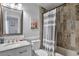 Bathroom featuring stylish granite countertops, neutral paint and tiled shower at 9889 Aftonwood St, Highlands Ranch, CO 80126