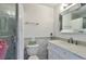 Bright bathroom with a mosaic tiled shower and modern vanity at 9889 Aftonwood St, Highlands Ranch, CO 80126