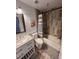 A well-lit bathroom has tiled walls, a modern vanity, and a shower with a bathtub at 9889 Aftonwood St, Highlands Ranch, CO 80126