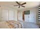 Bedroom with closet, ceiling fan, television, and access to a shower room at 9889 Aftonwood St, Highlands Ranch, CO 80126