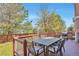 Outdoor deck with a dining table and chairs, perfect for entertaining and enjoying the beautiful backyard view at 9889 Aftonwood St, Highlands Ranch, CO 80126