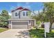 Charming two-story home with gray siding, a two-car garage, landscaped yard, and inviting front porch at 9889 Aftonwood St, Highlands Ranch, CO 80126