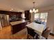 Open kitchen with stainless steel appliances, dark cabinets, and a view to the outdoor living space at 9889 Aftonwood St, Highlands Ranch, CO 80126