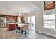 Bright, open kitchen and dining area with cherry cabinets, stainless steel appliances, and deck access at 9889 Aftonwood St, Highlands Ranch, CO 80126