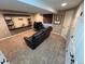 Finished basement featuring modern black shelves and a comfortable leather couch at 9889 Aftonwood St, Highlands Ranch, CO 80126