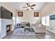 Inviting living room featuring a fireplace, high ceilings, large windows, and stylish decor at 9889 Aftonwood St, Highlands Ranch, CO 80126