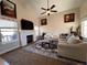 Inviting living room featuring a fireplace, vaulted ceiling, and large windows for ample natural light at 9889 Aftonwood St, Highlands Ranch, CO 80126