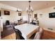 Spacious living room and dining area featuring hardwood floors, elegant lighting, and a vaulted ceiling at 9889 Aftonwood St, Highlands Ranch, CO 80126