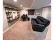 Finished basement featuring modern black shelves and a comfortable leather couch at 9889 Aftonwood St, Highlands Ranch, CO 80126