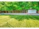 Backyard view with ample lawn space, mature shade trees, and a large structure for birds or small animals at 12234 W Saratoga Ave, Morrison, CO 80465