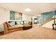 Finished basement includes a lounge area, staircase, neutral carpet and ample lighting at 12234 W Saratoga Ave, Morrison, CO 80465