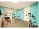 Finished basement includes exercise equipment, large mirrors, and bright turquoise accent wall at 12234 W Saratoga Ave, Morrison, CO 80465