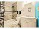 Bathroom features modern fixtures, tiled shower with glass, and contemporary vanity with ample storage at 12234 W Saratoga Ave, Morrison, CO 80465