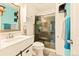 Bathroom featuring updated vanity, toilet and tile shower with glass door at 12234 W Saratoga Ave, Morrison, CO 80465