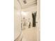 Bright bathroom featuring a pedestal sink, toilet, and unique shower with vertical ribbed glass at 12234 W Saratoga Ave, Morrison, CO 80465