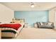 Comfortable bedroom with blue accent wall, neutral carpet, a sofa and natural light at 12234 W Saratoga Ave, Morrison, CO 80465