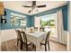 Dining room featuring wainscotting, a decorative mirror and a large window at 12234 W Saratoga Ave, Morrison, CO 80465