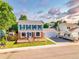 Charming two-story home with blue shutters, brick accents, a well-maintained lawn, and a spacious driveway at 12234 W Saratoga Ave, Morrison, CO 80465