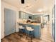 Bright kitchen featuring a breakfast bar, stainless steel appliances, and stylish blue cabinetry at 12234 W Saratoga Ave, Morrison, CO 80465