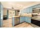 Updated kitchen with stainless steel appliances and a view to the backyard at 12234 W Saratoga Ave, Morrison, CO 80465