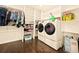 Bright laundry room with modern appliances, built-in shelves, and ample storage space at 12234 W Saratoga Ave, Morrison, CO 80465