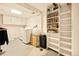 Bright laundry room includes modern washer and dryer, white cabinetry, and plenty of storage at 12234 W Saratoga Ave, Morrison, CO 80465