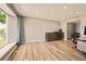 Spacious living room featuring hardwood floors and ample natural light from a large window at 12234 W Saratoga Ave, Morrison, CO 80465