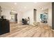 Bright, open-concept living area featuring wood floors and access to the dining area and second living space at 12234 W Saratoga Ave, Morrison, CO 80465