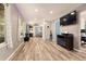 Inviting living room featuring wood-look floors, recessed lighting and seamless flow into the kitchen at 12234 W Saratoga Ave, Morrison, CO 80465