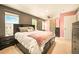 Spacious main bedroom featuring barn door to closet, dual windows, and ceiling fan at 12234 W Saratoga Ave, Morrison, CO 80465