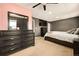 Spacious main bedroom with a large bed, dresser, ceiling fan and neutral carpet at 12234 W Saratoga Ave, Morrison, CO 80465