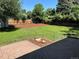 An expansive green backyard with a stone area and privacy fencing at 2836 S Fenton St, Denver, CO 80227