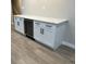 Basement wet bar with white cabinetry, wine cooler, and quartz counters at 2836 S Fenton St, Denver, CO 80227
