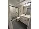 Bathroom with walk-in shower with black framed mirror and vanity at 2836 S Fenton St, Denver, CO 80227