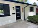 Close up of a modern front door on a painted brick home with updated fixtures at 2836 S Fenton St, Denver, CO 80227