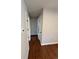 Hallway with hardwood floors featuring white doors and neutral wall paint at 2836 S Fenton St, Denver, CO 80227