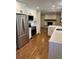Open kitchen layout featuring stainless steel appliances, and views into living area with fireplace at 2836 S Fenton St, Denver, CO 80227