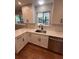 Bright kitchen with stainless steel appliances, white cabinetry and quartz counters at 2836 S Fenton St, Denver, CO 80227