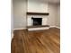 Inviting living room with a brick fireplace, refinished wood floors and neutral paint at 2836 S Fenton St, Denver, CO 80227
