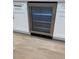 Close up view of wine cooler surrounded by custom white cabinetry at 2836 S Fenton St, Denver, CO 80227