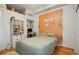 Cozy bedroom features built-in shelving, wood floors, and a unique wooden headboard at 474 N Inca St, Denver, CO 80204