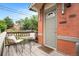 Quaint front porch features seating area and stylish entry door at 474 N Inca St, Denver, CO 80204