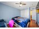 This bedroom features hardwood floors and a sliding door closet at 4931 S Danube St, Aurora, CO 80015