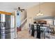 Open-concept kitchen flowing into the dining area, featuring stainless steel appliances and tile flooring at 4931 S Danube St, Aurora, CO 80015