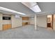 Finished basement area with neutral carpet, built-in cabinetry, and lighting at 10222 W Ida Ave # 237, Littleton, CO 80127