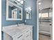 Stylish bathroom with a white marble vanity top and sleek shower featuring modern fixtures at 10222 W Ida Ave # 237, Littleton, CO 80127