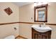 Bathroom with updated vanity, decorative mirror, and neutral color scheme at 10222 W Ida Ave # 237, Littleton, CO 80127