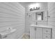 Stylish bathroom with a modern vanity, shiplap walls, and updated fixtures at 10222 W Ida Ave # 237, Littleton, CO 80127
