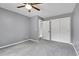 Comfortable bedroom featuring soft carpet, a ceiling fan, and a spacious closet at 10222 W Ida Ave # 237, Littleton, CO 80127