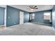 Bedroom with wall-to-wall carpet, a ceiling fan, and natural light from two windows at 10222 W Ida Ave # 237, Littleton, CO 80127